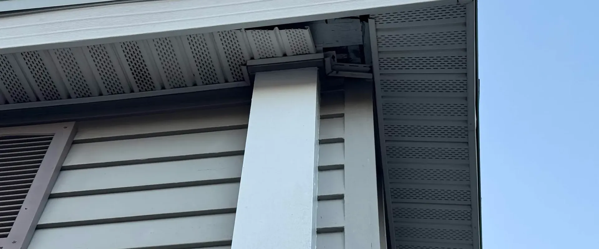 Dark gray Mastic vent hidden soffit and fascia at a modern Tampa Bay home gable end