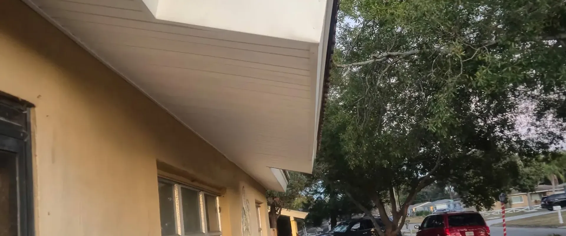 Clean white soffit and fascia under a Spanish tile roof on a Tampa Bay stucco home
