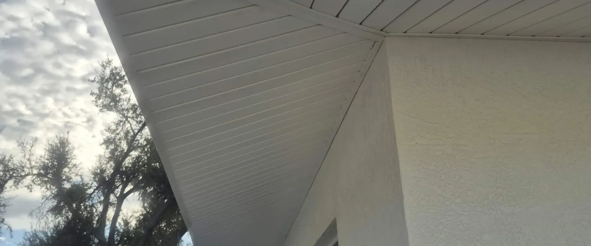 Clean white vented soffit and fascia on a modern stucco home in Tampa Bay